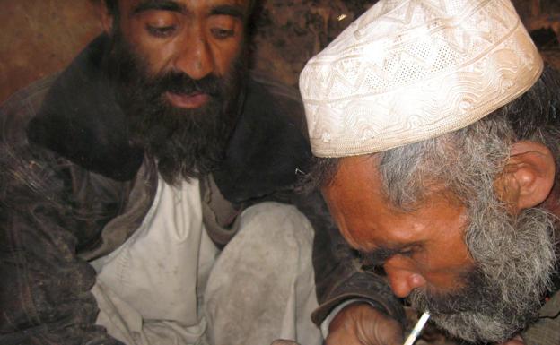 Un drogadicto afgano fuma heroína en una zona marginal de la capital./jalil rezayee / efe