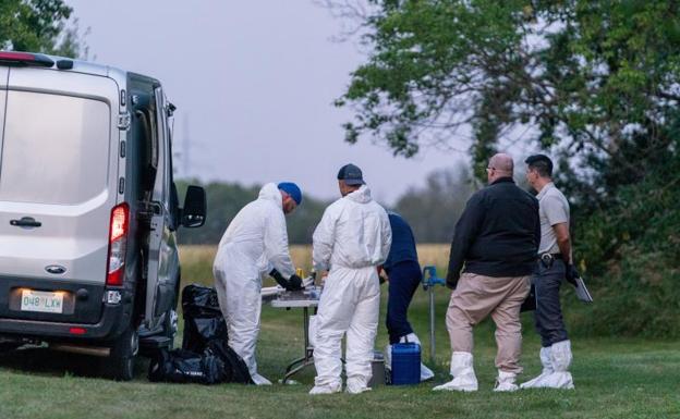 Investigators collect evidence at the scene.