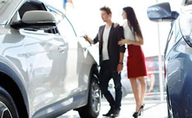 File image of a couple looking for a vehicle at a dealership. 